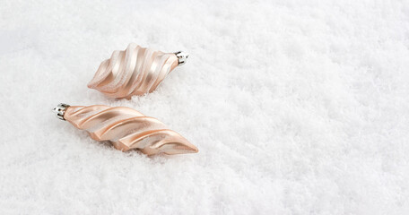 Pastel Christmas toys on a snowdrift. New Year banner. Selective focus, copy space