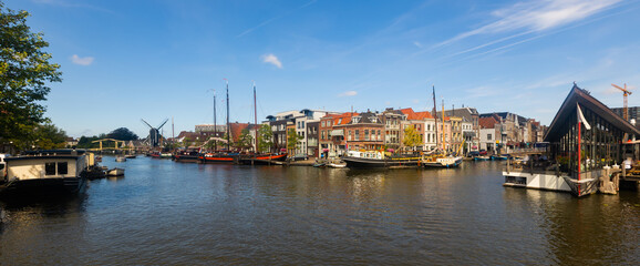 Fototapeta premium Quay with moored ships along Oude Rijn river in Leiden, Netherlands.