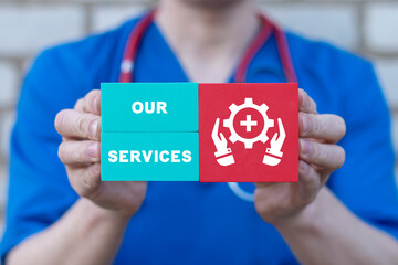 Doctor holding colorful styrofoam blocks sees inscription: OUR SERVICES. Health care concept of our services promotion. Medical, Pharmacy Service, Development, Modern, Solutions.