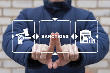 Politician using virtual touch screen presses text: SANCTIONS. Concept of sanctions. International...
