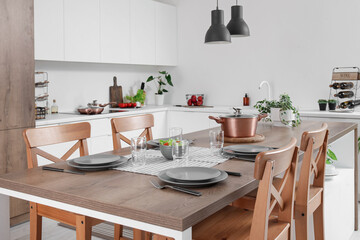 Interior of modern kitchen with served island table
