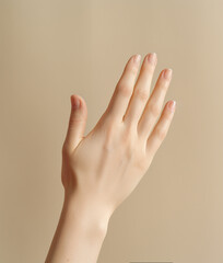 Female hand on beige background.