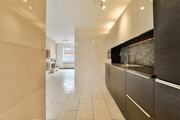 a modern kitchen with tile flooring and white tiles on the walls, in an open space that has been used for many years