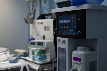The gas anesthesia machine stands in a clean light surgery ready for operation. A ventilator ready...
