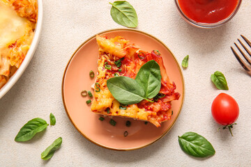 Plate of pasta with tomato sauce and cheese on grey background