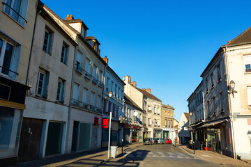 Naklejka na ściany i meble Street of Montmirail, Marne department, France. View of neat buildings with signboards.