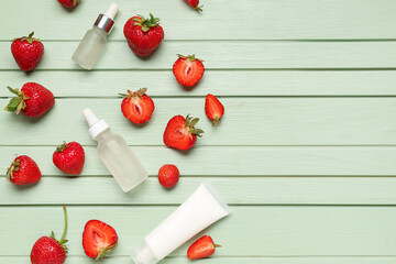 Naklejka na ściany i meble Different cosmetic products and strawberries on green wooden background