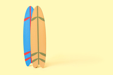 Different mini surfboards on pale yellow background