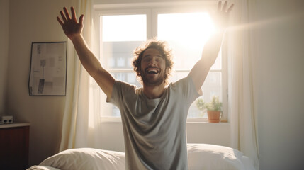 a man waking up in the morning, Stretches and gets out of bed, Sun shines from the apartment window in bedroom.