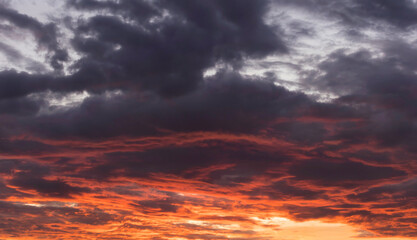 Real amazing sunrise or sunset sky with gentle colorful clouds