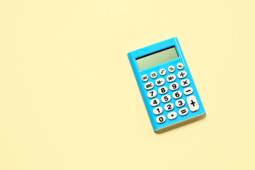 Modern calculator on pale yellow background