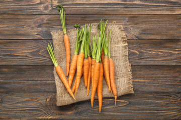 Many fresh carrots on wooden background