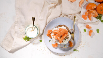 Pancakes with yogurt and tangerines