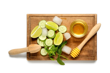 Wooden cutting board with cucumber, mint and honey on white background. Ingredients for mojito