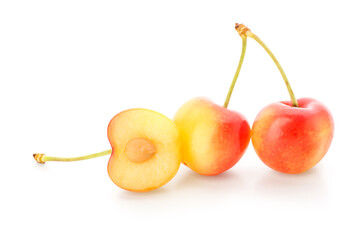 Sweet yellow cherries with half on white background