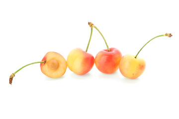 Sweet yellow cherries with half on white background