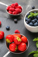 Composition with different fresh berries on grey background, closeup