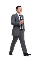 Businessman in suit with cup of drink walking on white background