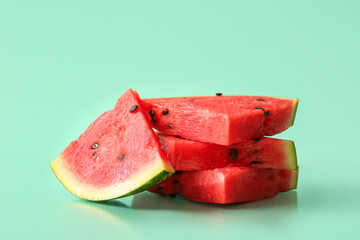 Pieces of fresh watermelon on turquoise background