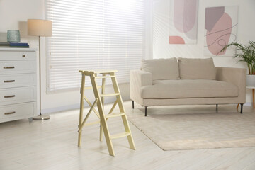Folding ladder on wooden floor at home