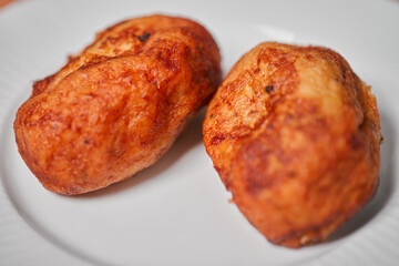 Close up photo of empanadas dessert from El Salvador central america made of bean paste and milk on wooden block and white dish
