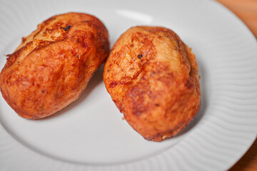Close up photo of empanadas dessert from El Salvador central america made of bean paste and milk on wooden block and white dish