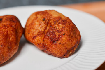 Close up photo of empanadas dessert from El Salvador central america made of bean paste and milk on wooden block and white dish