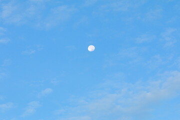 beautiful moon in the blue sky on a clear morning