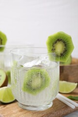 Glass of refreshing drink with kiwi on table