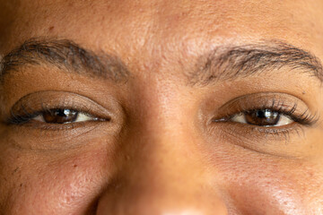 Close up of eyes of biracial casual businessman smiling
