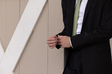 Groom adjusting cuffs
