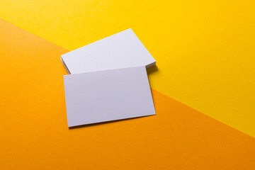 White business cards with copy space on yellow and orange background