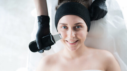 Woman on ultrasonic cleaning procedure. Hardware cosmetology.  - obrazy, fototapety, plakaty