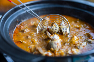 Bowl of sea snail in spicy sauce