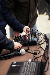 audio system at the concert. preparing the speaker system for the event, a person connects and adjusts the acoustics for the performance.