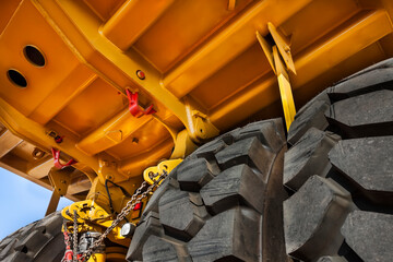 revision of suspension , double axle under a huge brand new yellow mining truck