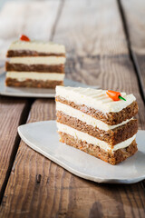 Delicious cake on plate on brown wooden table 