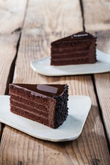 Delicious cake on plate on brown wooden table 