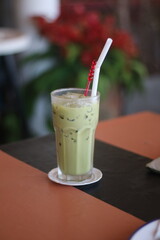 Closeup of Iced Caramel Macchiato at the coffee shop, Caramel Macchiato is a classic macchiato beverage. It consists of vanilla syrup, espresso, steamed milk, foam, and caramel drizzle