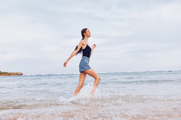 Fototapeta na wymiar wave woman sea smile sunset running beach lifestyle young travel summer