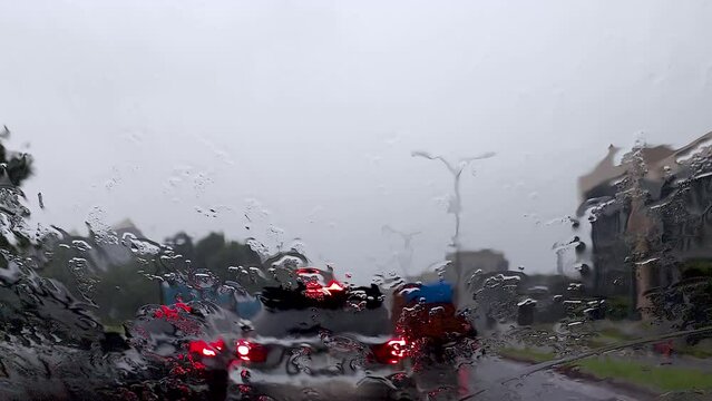 Blurred city street at rainy day, view from inside the car.