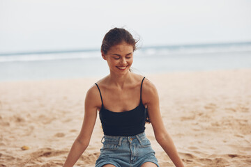Fototapeta premium woman travel vacation carefree sea sand sitting freedom nature beach smile