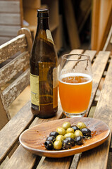 Bowl of mixed olives and glass of beer