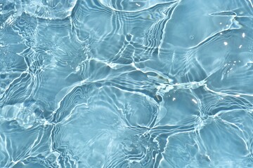 Blue water with ripples on the surface. Defocus blurred transparent blue colored clear calm water...