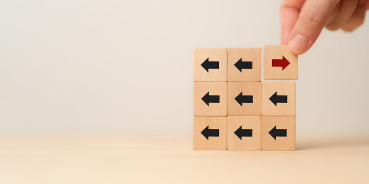 New ways of working, differentiation strategy concept  symbol on wood blocks. Providing uniqueness, different and distinct from competitors, creating competitive advantage. Business direction concept.