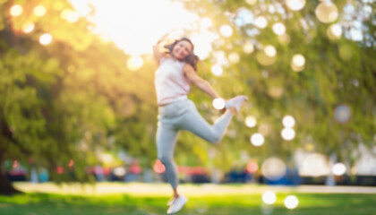 Defocused bokeh effect positive concept background of unrecognizable people enjoying healthy lifstyle exercising fitness outside