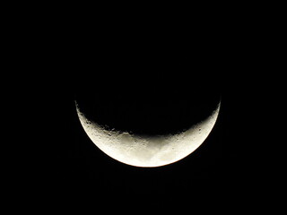 Half curved Moon. It is an astronomical body that orbits planet Earth.