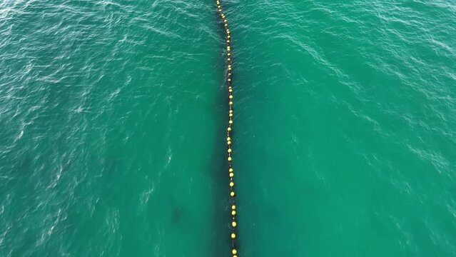 Aerial flyover protective shark net in ocean of Australia protecting tourist for sharks 