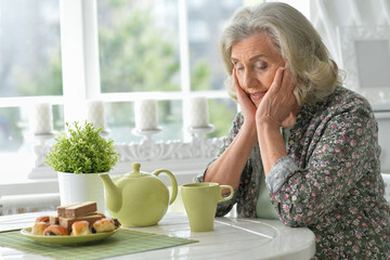 Beautiful smiling senior woman drinking tea