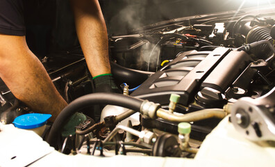 Auto mechanic working in auto repair service. Car mechanic working on a car engine.